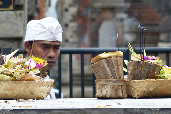 A Balinese healer is praying in a temple