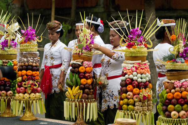 A group of women presenting the mountain of fruits offering in a village temple