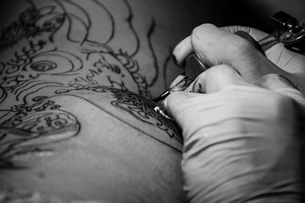 Tattoo artist working