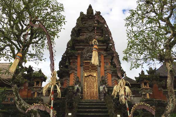 temple in ubud with beautiful bali-style main gate and penjor